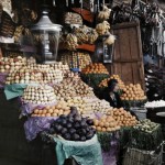 A woman sits with her fruits for sale. Photo Credit: Gervais Courtellemont and W. Robert Moore for National Geographic